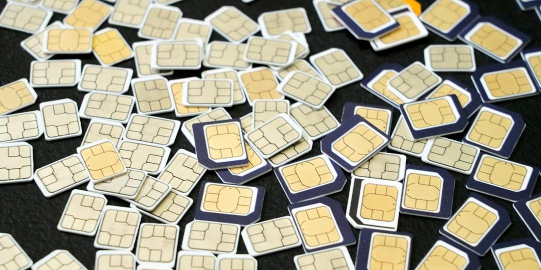 Multiple SIM cards scattered on a black surface, showcasing the complexity of cellular technology.